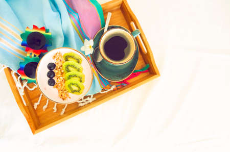 Cup of granola with yogurt and fruit on white backgroundの写真素材