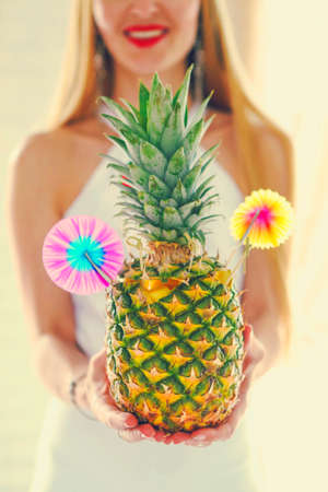 Pina colada in pineapple in woman handsの写真素材