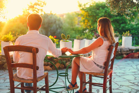 Young couple in love sit outdoors in restaurantの写真素材