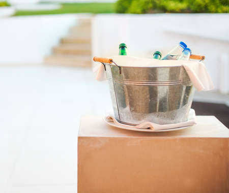 Ice bucket with mineral water outdoorsの写真素材