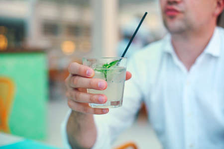 Man with cocktail glass in his handの写真素材
