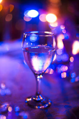 Wineglass outdoors on table by nightの写真素材