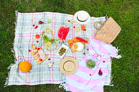 Picnic background with white wine on green grass