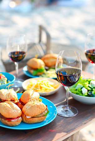 Beach summer picnic table with red wine glasses