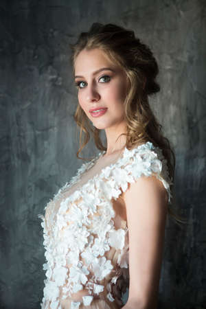 Portrait of beautiful young woman on dark backgroundの写真素材