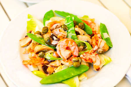 Fresh salad with shrimps, mushrooms, capers with green peasの写真素材