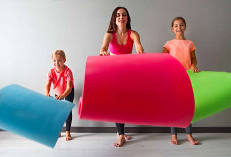 Young woman having fun with kids after yoga