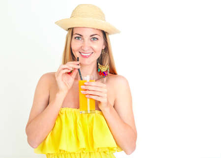 Funny portrait of smiling woman with hat on eyes drinking orange juice