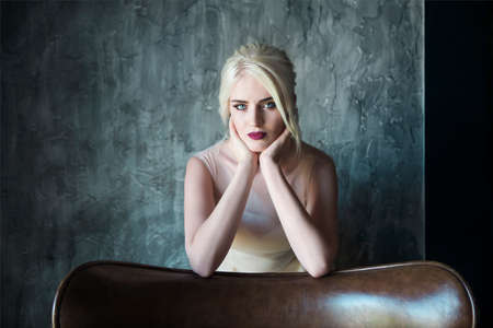 Portrait of beautiful young woman on dark background