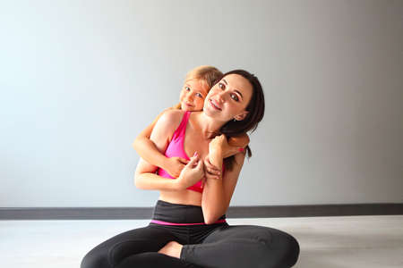 Young woman having fun with girl after yogaの写真素材