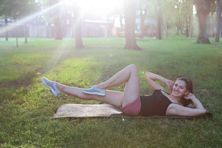 Stretching woman in outdoor exercise smiling happy doing stretches after running. Beautiful happy...