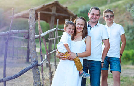 Portrait of the happy family with ltwo sons having fun outdoorsの写真素材