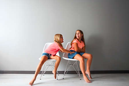 Furious teen girl in a discussion with her little. Problems between sisters conceptの写真素材