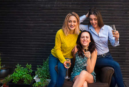 Group of partying girls with flutes with sparkling wine having fun on the partyの写真素材