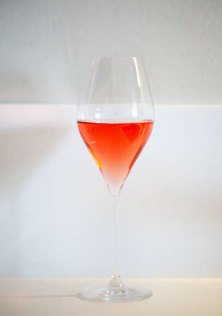 One glass of rose wine on white backgroundの写真素材