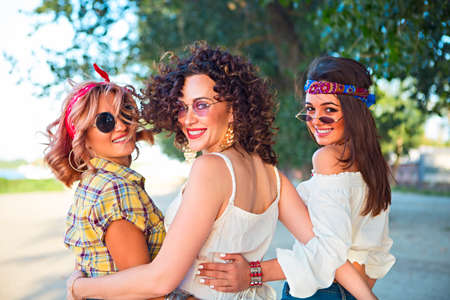 Happy slim tan women are dancing on the beach in sunset. Travel and happiness conceptの写真素材