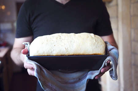 Male hands form with fresh dough on the kitchen. Close upの写真素材