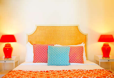 Comfortable pillows on bed decoration in hotel bed room interior with lampsの写真素材