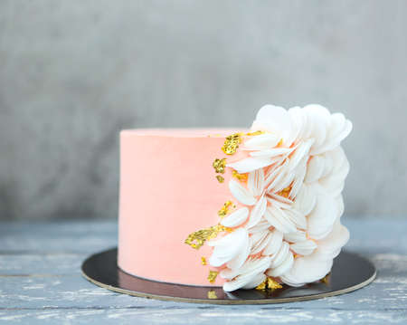 Mini stylish pink wedding cake with wafer paper and gold decorの写真素材