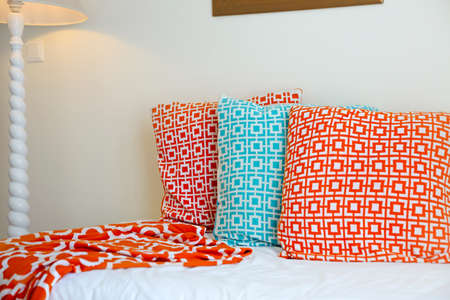 Comfortable pillows on white bed decoration on the sofaの写真素材