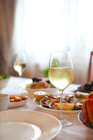 People fine dining seafood and white wine on the table