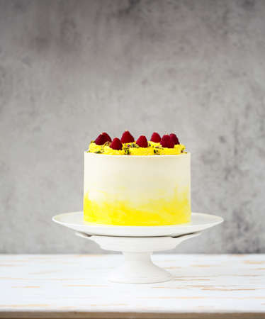 Beautiful happy birthday cake with mascarpone decorated with raspberry, pistachio and candles