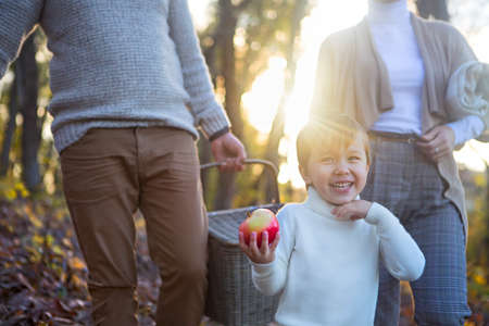 Happy family together going to autumn picnic in the evening