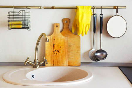 Interior of empty modern white kitchen with various objects on the tableの写真素材