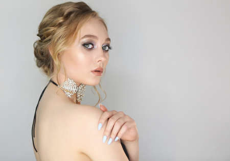 Portrait of a beautiful young blonde woman. Woman with fashion hairstyle and make up. Trendy black...