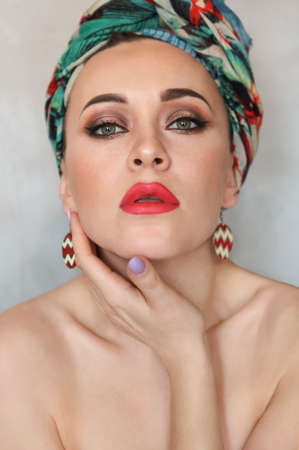 Close up portrait of the young beautiful woman in turban