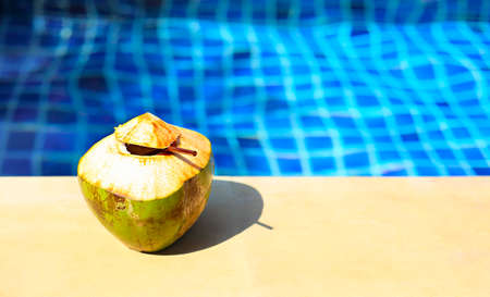 Coconut water drink by the Swimming pool with copy space. Holiday, summer, travel conceptの写真素材