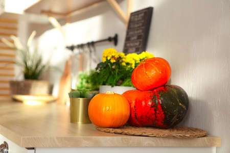 Detail little white modern kitchen with pumpkins on the wood worktopの写真素材