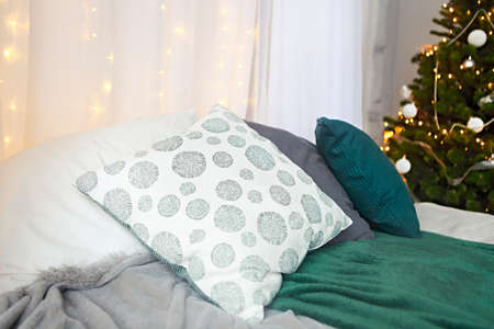 Christmas design of the bedroom. Christmass tree with presents in the room