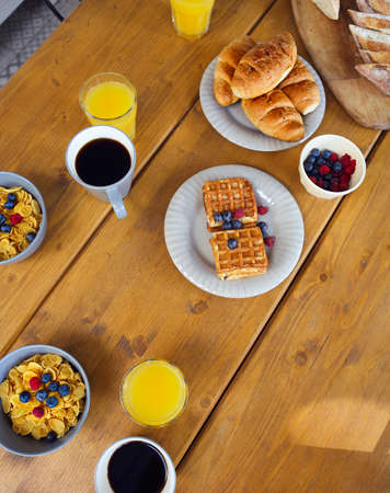 Breakfast on the wooden table. Top viewの写真素材