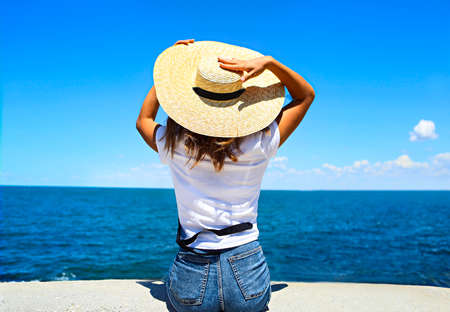 Young happy blond woman at beautiful tropical paradise view of ocean enjoying summer holidays. Travel and tourist conceptの写真素材