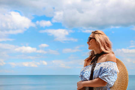 Young happy blond woman at beautiful tropical paradise view of ocean enjoying summer holidays. Travel and tourist conceptの写真素材