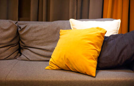 Living room interior with grey sofa and yellow pillows on it. Cozy backgroundの写真素材