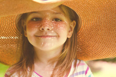 Portrait of the happy little girl blonde with long hair at sunset in lavender fieldの写真素材
