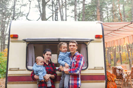 Portrait of the smiling happy family with kids in the house on wheels indoorの写真素材
