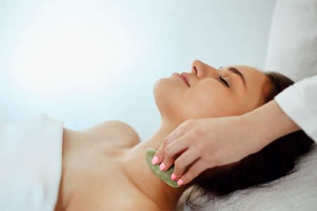 Face gua sha massage or beauty treatment in spa salonFace massage or beauty treatment in spa salonの写真素材