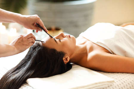 Face massage or beauty treatment for asian woman in spa salonの写真素材