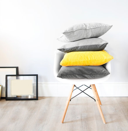 Chair in an interior with pillows in trendy colors. Concept of cozy and trendy interiorの写真素材