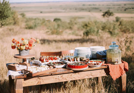 Catering bar with various snacks, buffet table during outdoor eventの写真素材