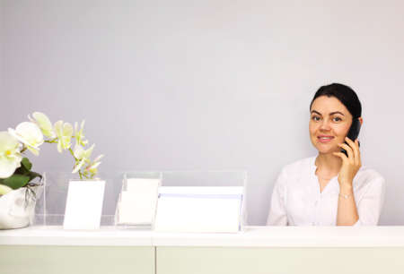 Brunette woman receptionist working in hospital