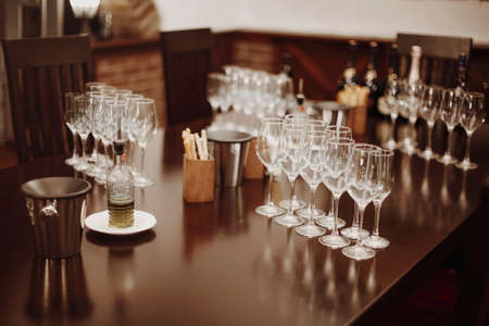 Glass goblets placed in rows on table during wine tasting procedure in restaurantの写真素材