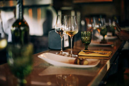 Wine bottle and glasses on the table, against the background of wine dinner. Serve wine. Winemaking concept, copy spaceの写真素材