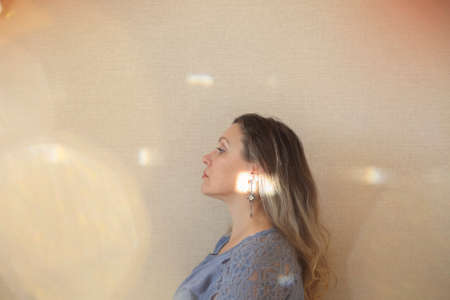 Love yourself at every age. Middle-aged 50s woman looking away while posing isolated over light...