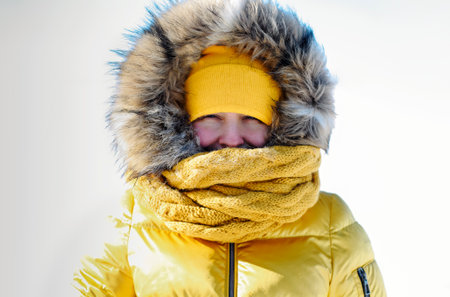 Portrait of blond real pretty woman in fur coat and yellow hat at winter background. Baikal lake....
