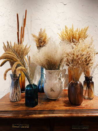 Composition with many different dried flowers in vases, on a light background.の写真素材
