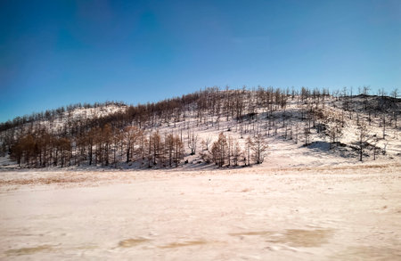 Beautiful empty paved road to Lake Baikal. Winter landscape. Travel and holiday concept